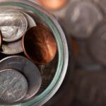 A realistic setup showing rare coins and banknotes being examined for an online auction.