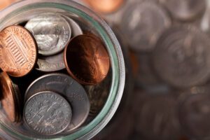 Discover the hidden value of your coins and banknotes through online auctions A realistic setup showing rare coins and banknotes being examined for an online auction.