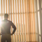 Exterior view of a modern home with automated fasade blinds protecting windows from summer sun.